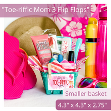 Load image into Gallery viewer, Gift basket kit in natural/tan. Striped tissue paper with pink, orange and red stripes. A tag is attached with a mini clothespin. The white tag reads, “for a toe-riffic mom” and has 3 flip flops in red and pink on the right side of tag. The basket is filled with many items used for a pedicure. The items pictured in the basket are for presentation purposes only. The gift basket comes empty ready for you to fill.