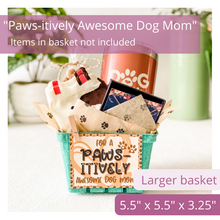 Load image into Gallery viewer, Image of green berry basket, cute tan colored tag with black paw prints in the background. It says: For a Paws-itively Awesome Dog Mom. Has a cute heart with a paw print under the text. The tag is attached to the basket with a cute mini clothespin. Also features cute kraft tissue paper with paw prints covering it. Items filling basket are dog themed, but do not come included in kit. Text overlay on image reads: Paws-itively Awesome Dog Mom. Items in basket not included. Larger Basket. 5.5 x 5.5 x 3.25.