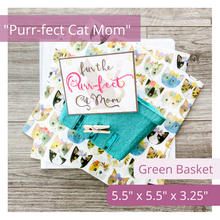 Load image into Gallery viewer, Image of a green basket, elegant tag featuring a cat silhouette and subtle pink and yellow paw prints in the background. The text on the tag reads: Fur the PURR-fect Cat Mom. Also features tissue paper with a darling cat print. Text overlay on image reads: Purr-fect Cat Mom. Green basket. 5.5 x 5.5 x 3.25.