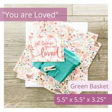 Load image into Gallery viewer, Image of an green basket, elegant tag featuring a delicate butterfly and floral print in the background. The text on the tag reads: Just because you are loved. Also features tissue paper with a gorgeous floral and butterfly print. Text overlay on image reads: You are Loved. Green Basket. 5.5 x 5.5 x 3.25.