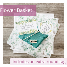 Load image into Gallery viewer, Image of green berry basket, elegant eucalyptus leaf tissue paper and white tissue paper. Also has a round tag attached to a stick and a mini clothespin. The round tag says, “Happy Mother’s Day.” Another tag is also in the image. It reads: &quot;A mother&#39;s love is more beautiful than any fresh flower.&quot; Debashish Mridha. The elegant tags feature delicate eucalyptus greenery.
